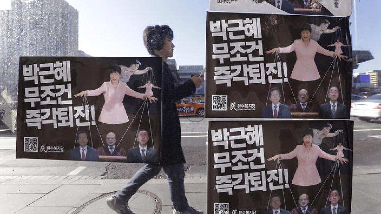 Posters depicting impeached South Korea's President Park Geun-hye manipulating her aides while she is also a marionette by her jailed confidante Choi Soon-sil.