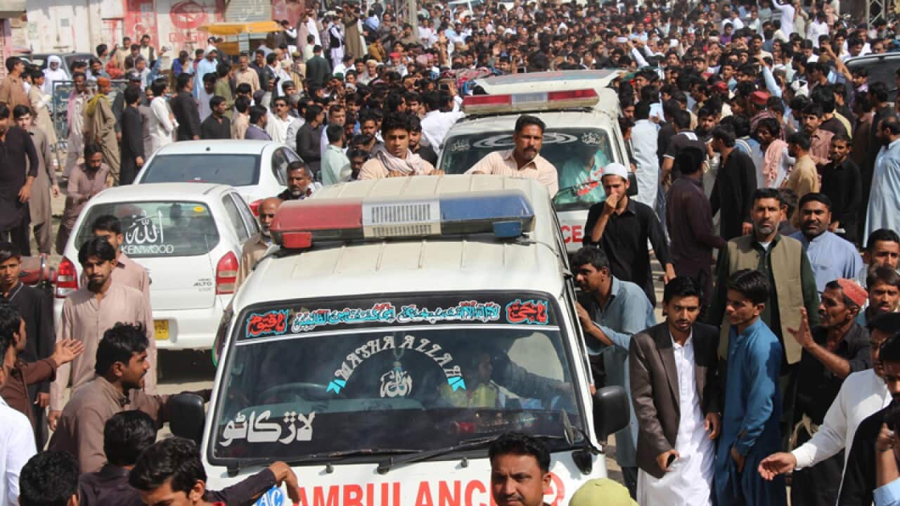 Ambulances carry victims who were killed in a suicide bomb attack