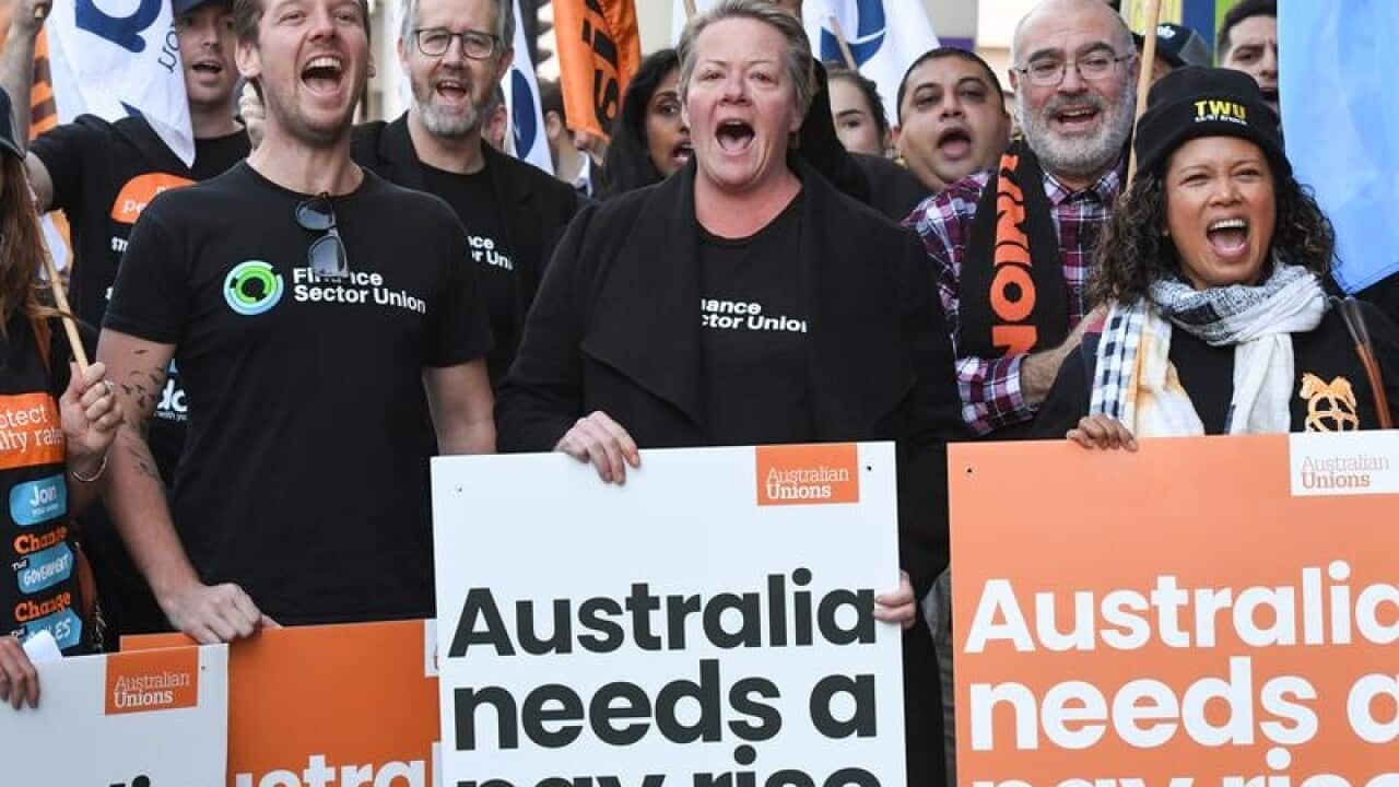 Union members rally outside a Fair Work Commission