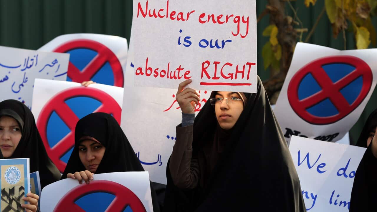 : An Iranian student holds a placard during a demonstration outside the Tehran Research Reactor.