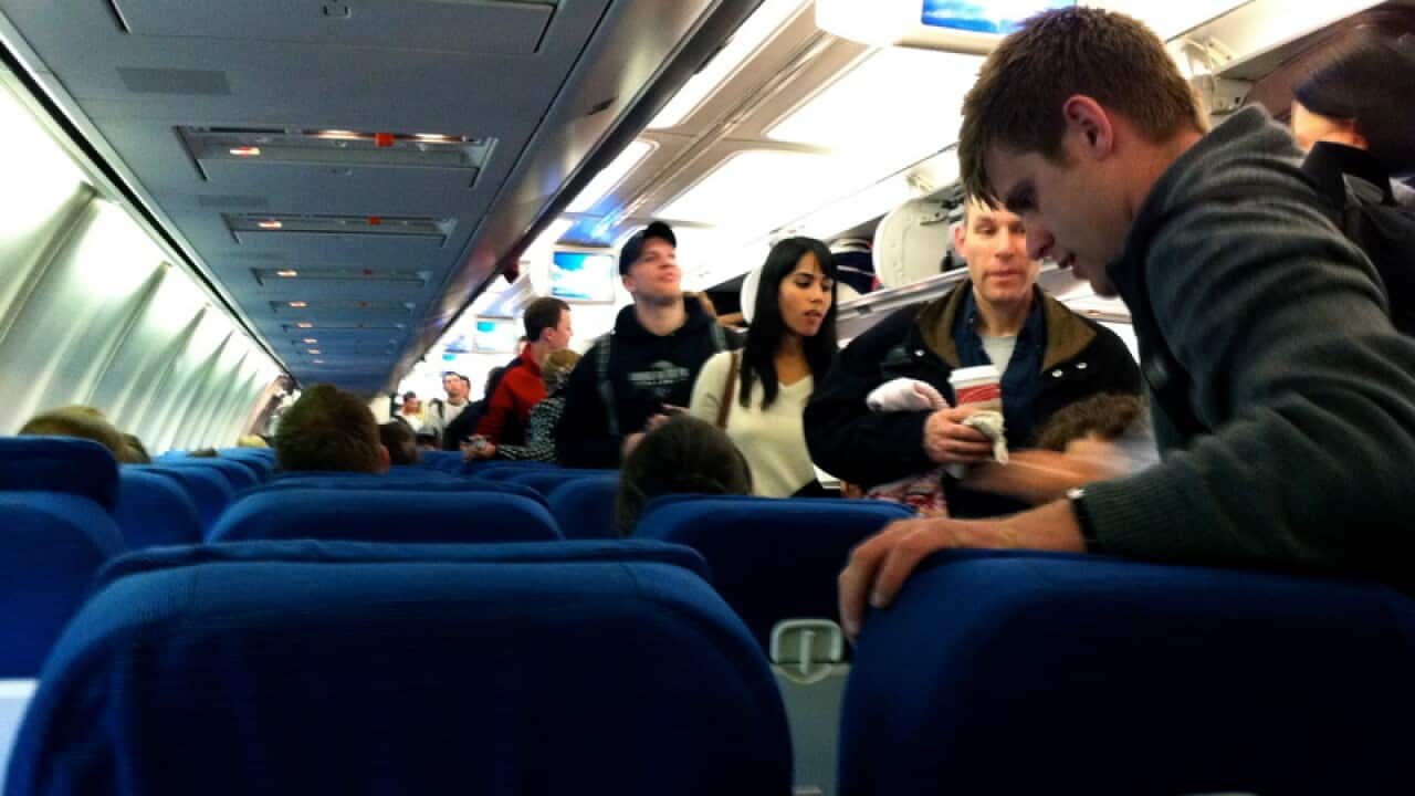 Passengers boarding an airplane from inside of the main cabin