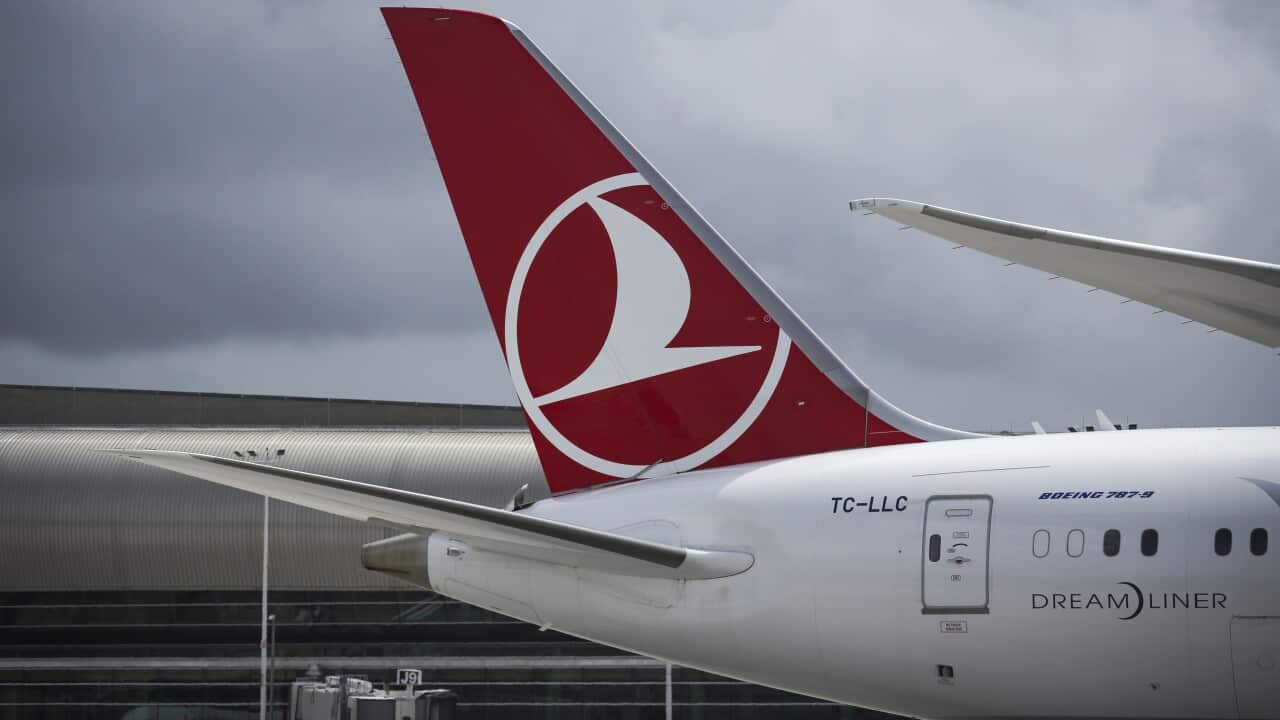 A Turkish Airlines plane parked on the tarmac at an airport.