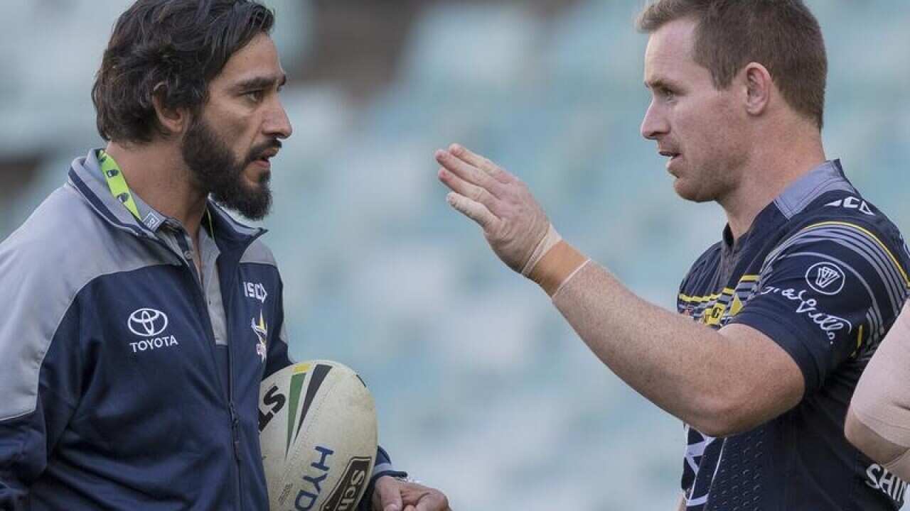 Johnathan Thurston talks with team during training.