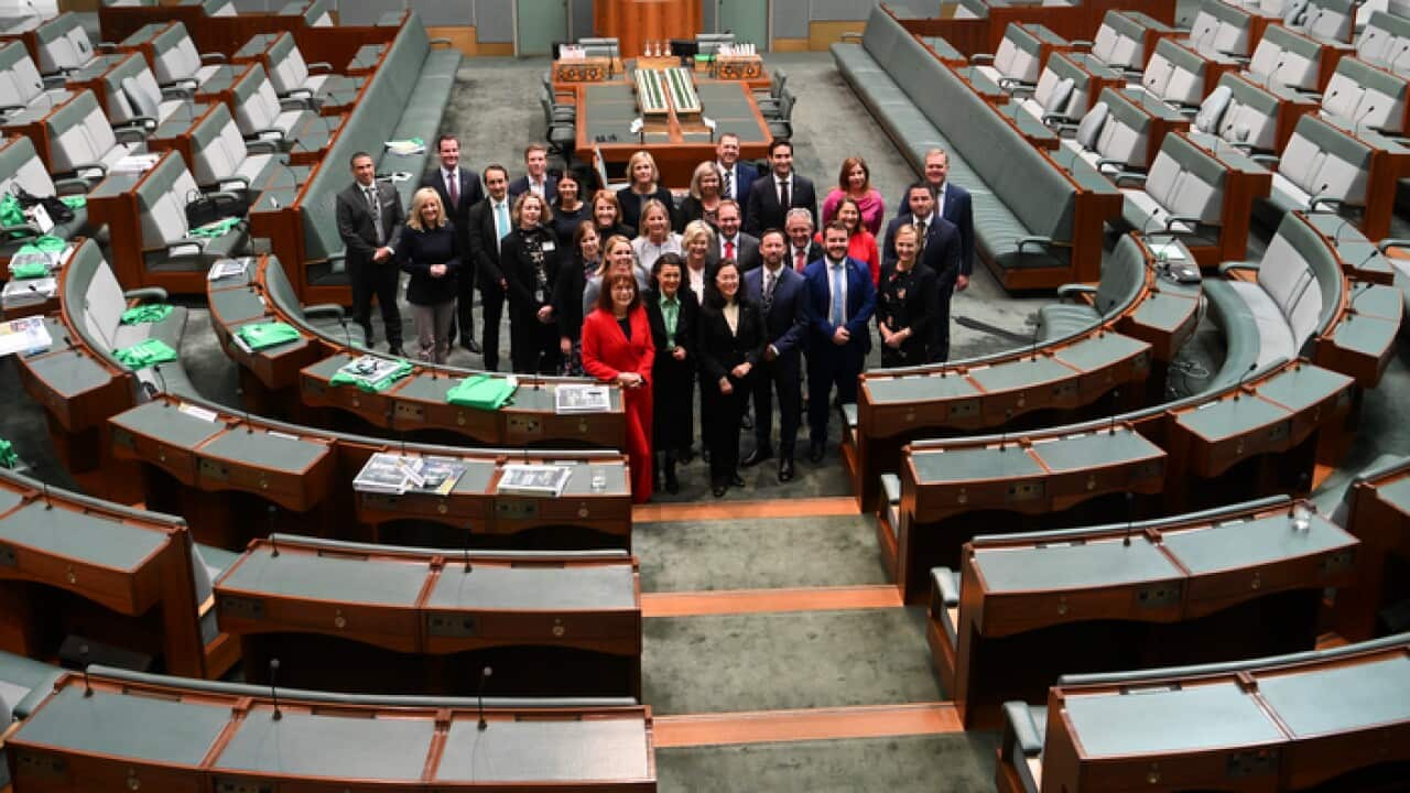 Newly elected MPs pose for photographs during a new Members' Seminar in the House of Representatives at Parliament House in Canberra.