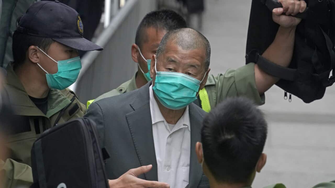 Jimmy Lai (centre) has been jailed for 12 months