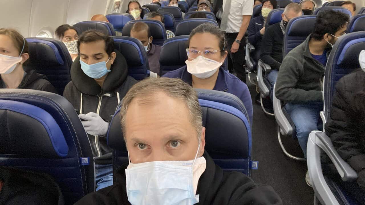 Passengers on board a packed United Airlines flight wear masks to protect themselves against the coronavirus.