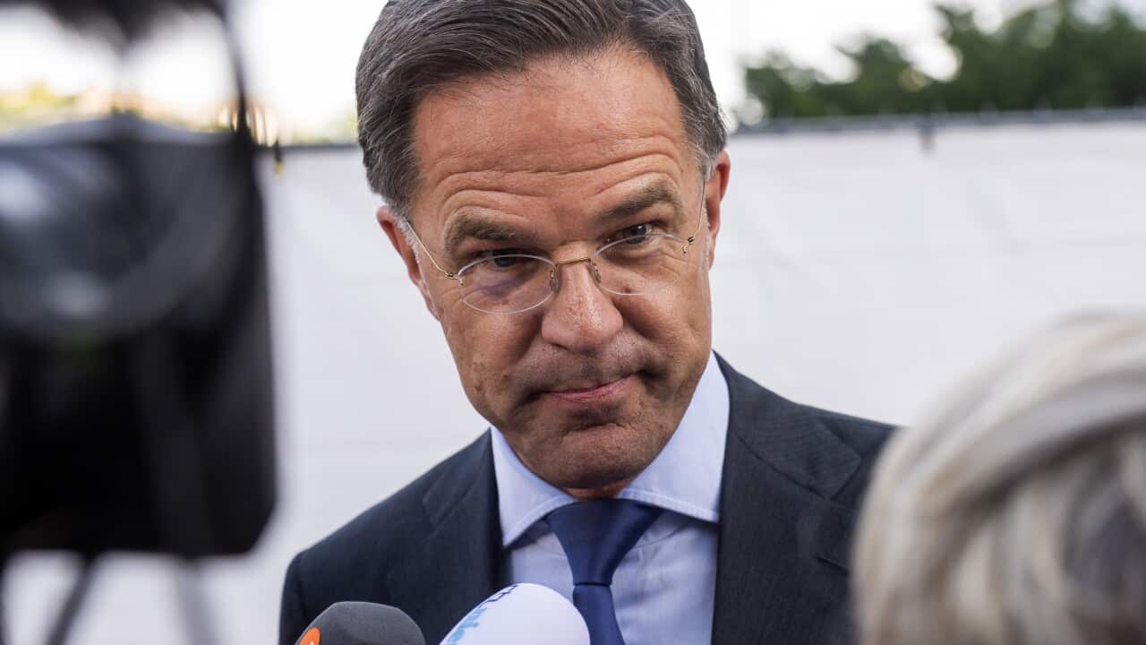 A man in a suit wearing glasses