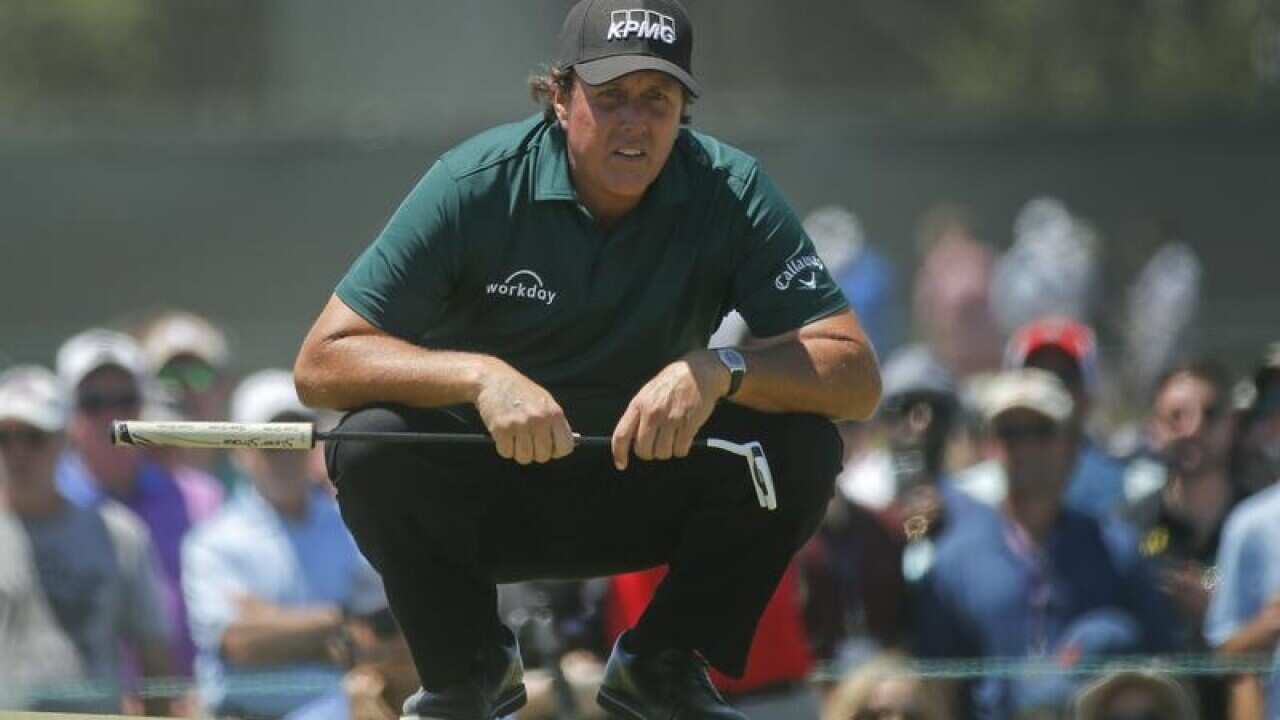Phil Mickelson lines up a shot during the U.S. Open
