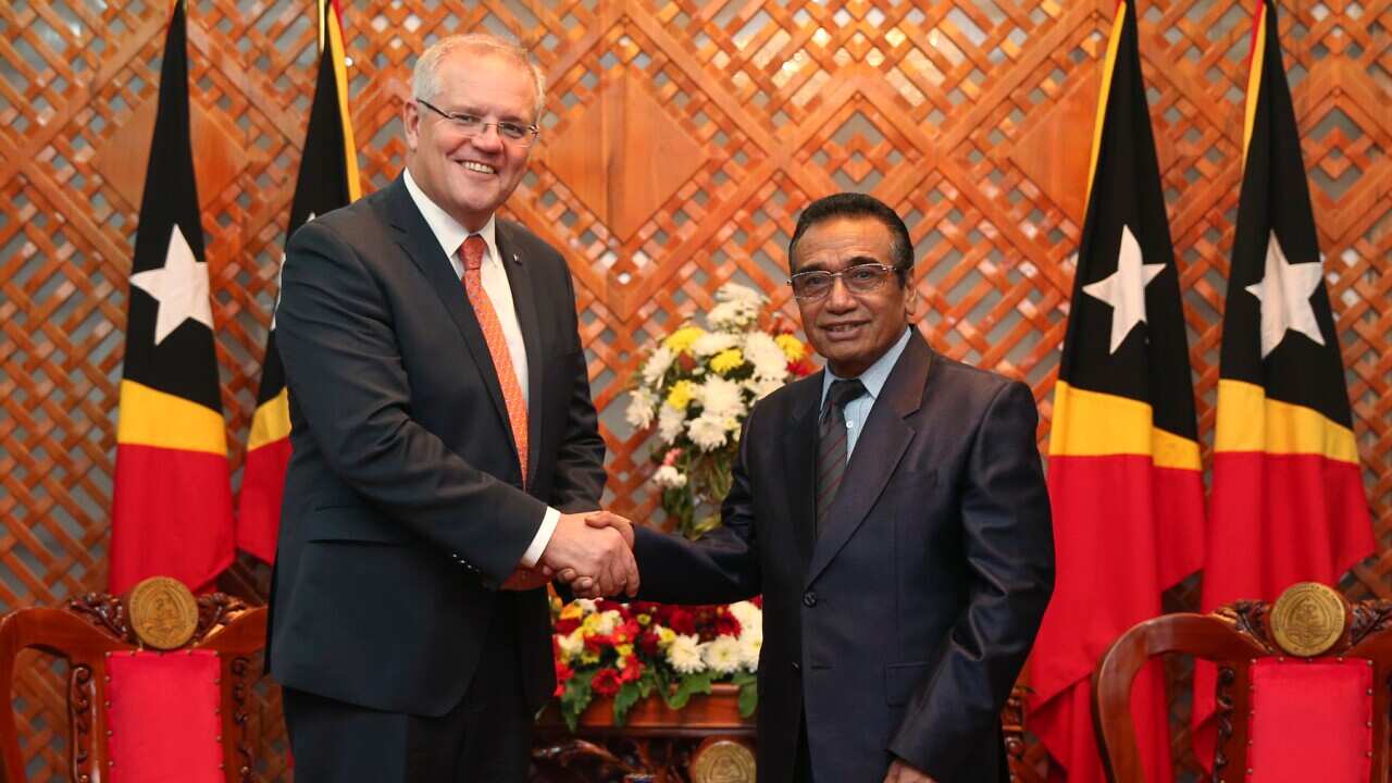 Australian Prime Minister Scott Morrison, left, shakes hands with East Timorese President Francisco Guterres