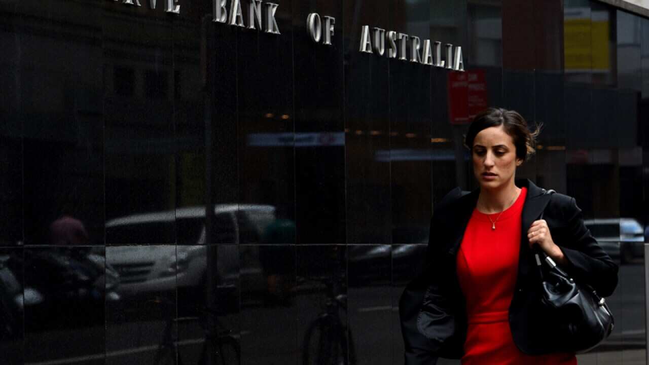 Pedestrians walk past the Reserve Bank of Australia in Sydney