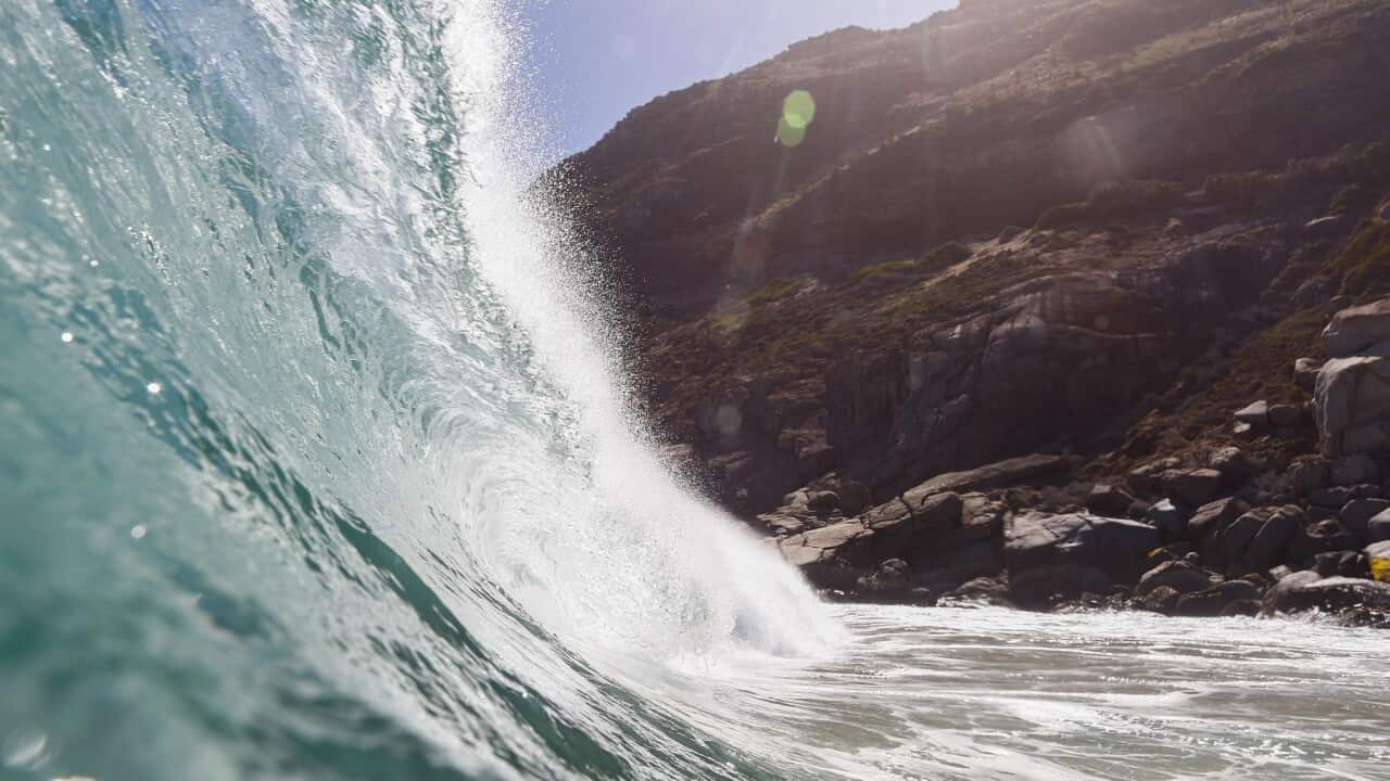 A wave breaks in the Atlanic Ocean