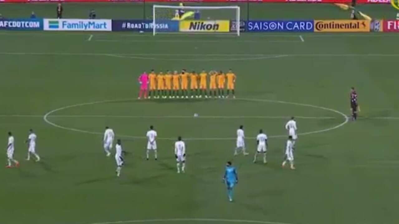 The moment during the Fox Sports telecast showing the Socceroos side lining up for the minute's silence, while the Saudi team disperse