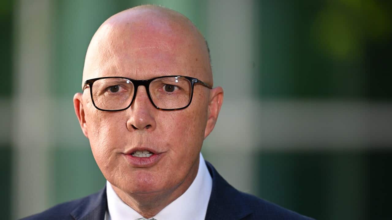 A bald man wearing glasses