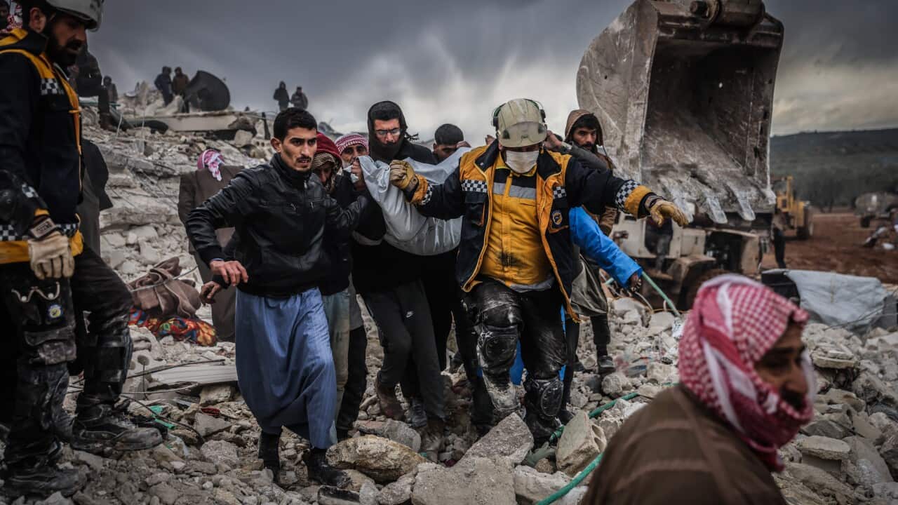 Rescuers carrying a survivor through the rubble