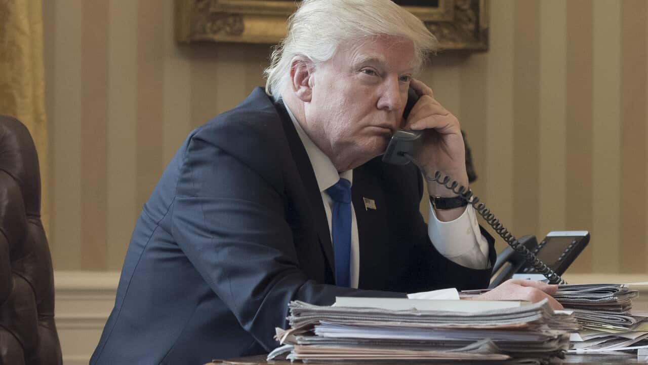 US President Donald Trump speaks on the phone with President of Russia Vladimir Putin, in the Oval Office.
