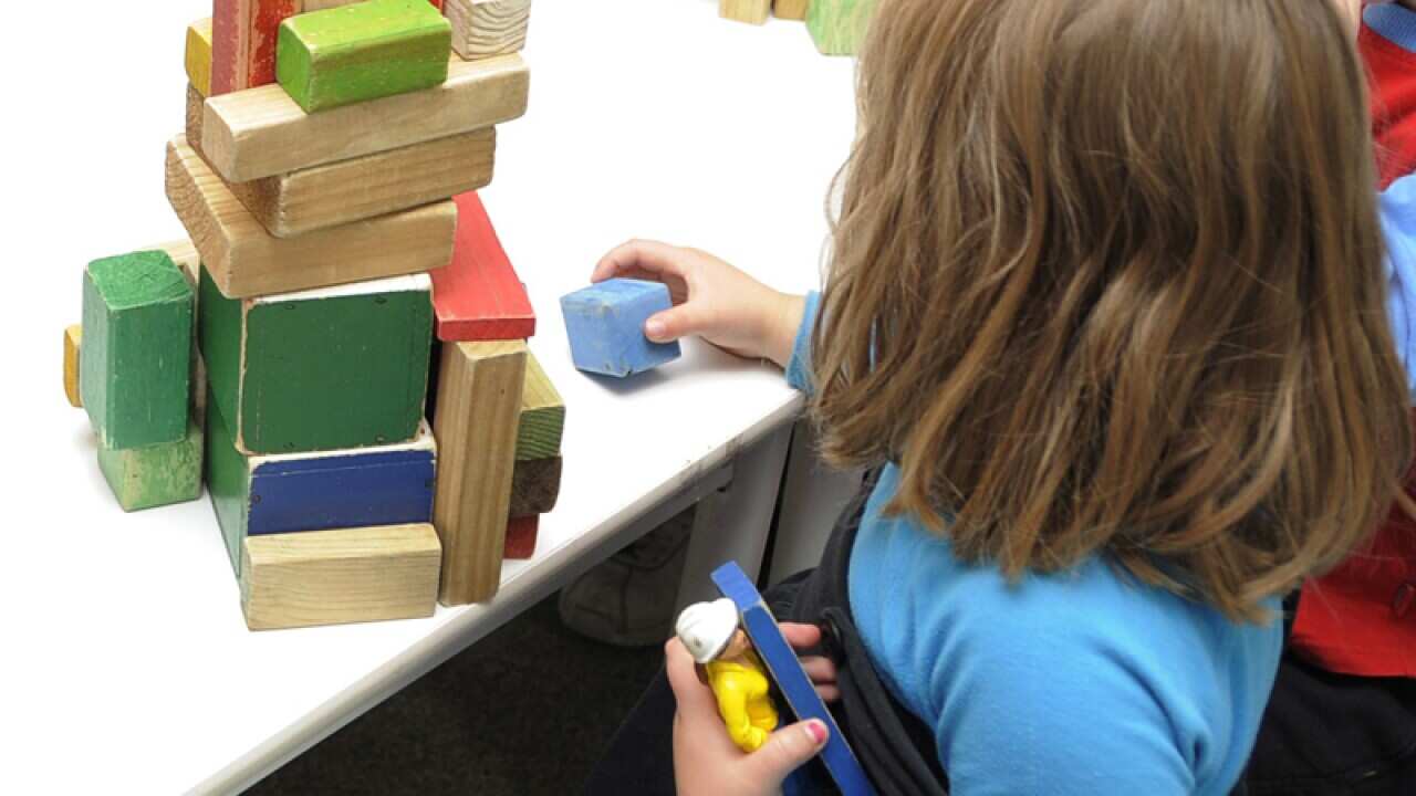 A child plays with toys at a preschool