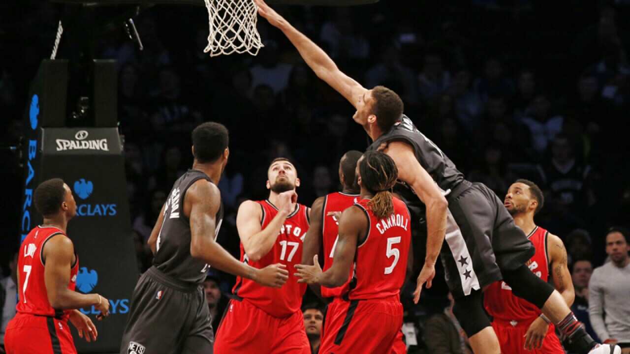Brooklyn Nets center Brook Lopez (R) lands a basket