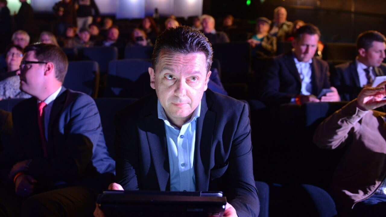Nick Xenophon checks results on a tablet