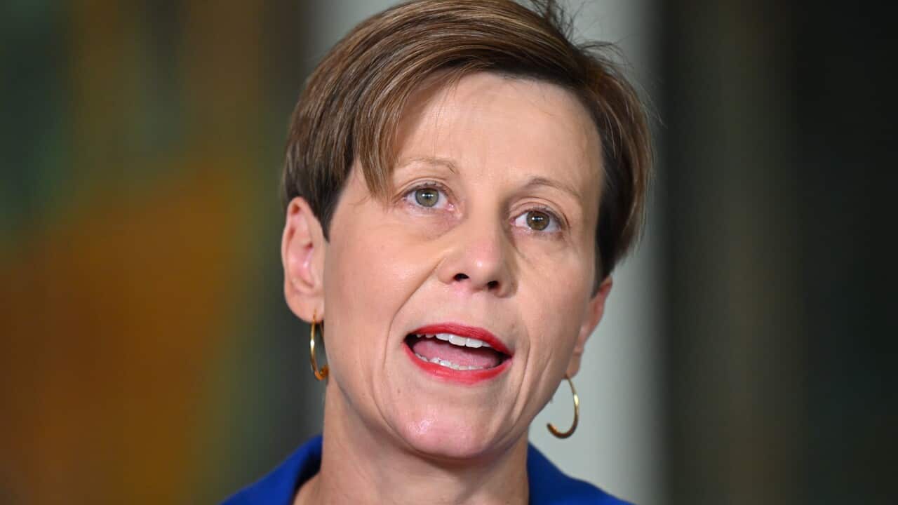 A close up shot of a woman wearing a blue jacket