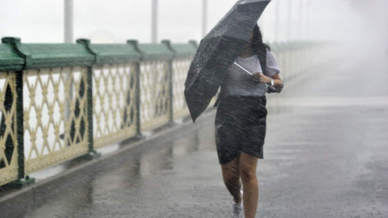 Pedestrians try to escape heavy rain
