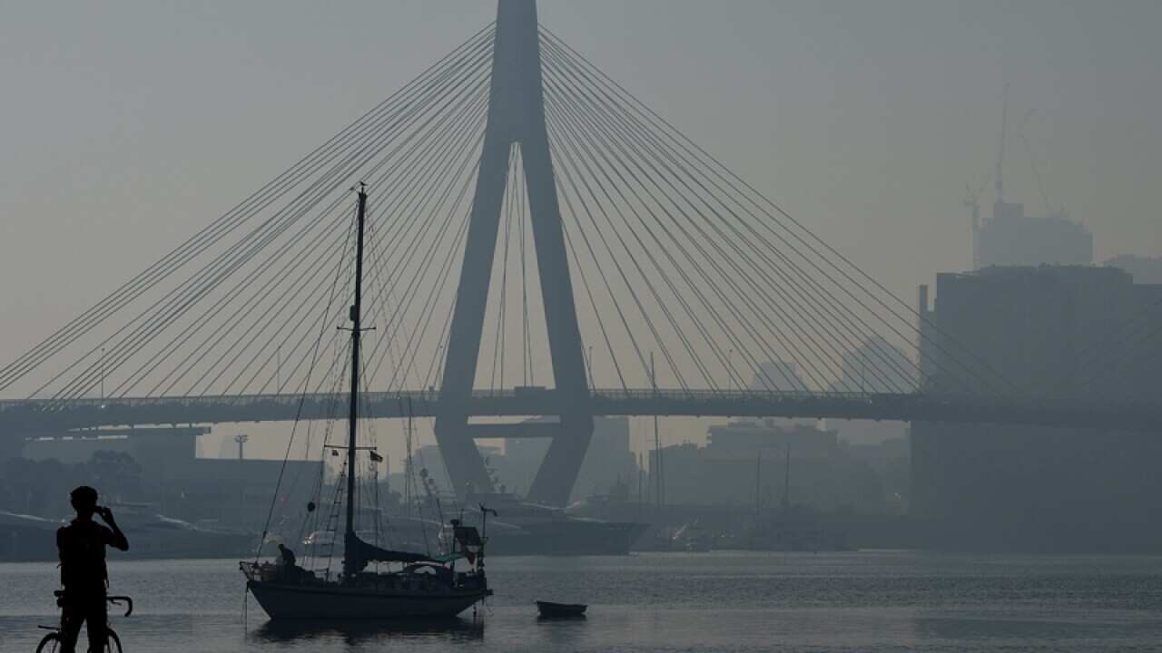 The Anzac Bridge is seen shrouded in smoke