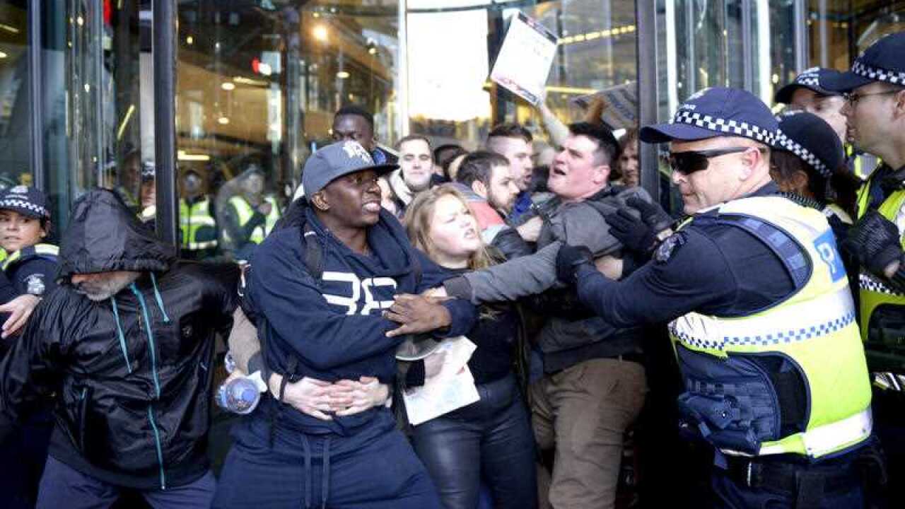 rotesters storm the entrances to the NAB building during protests ahead of the launch of Federal Education Minister Christopher Pyne's new book 'A Letter To My Children'. (AAP)