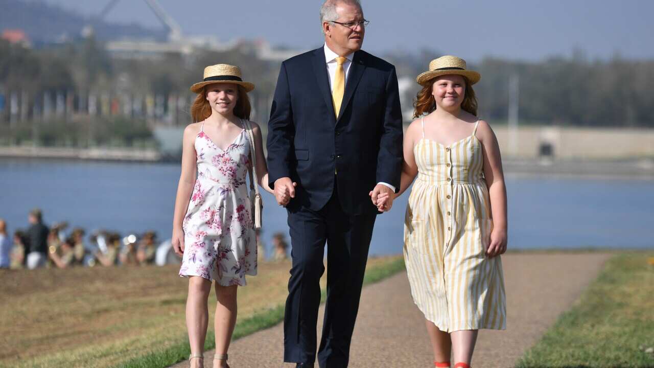 Prime Minister Scott Morrison and daughters Abbey and Lily arrive at an Australia Day Citizenship Ceremony and Flag Raising event in Canberra, Sunday, January 26, 2020. (AAP Image/Mick Tsikas) NO ARCHIVING