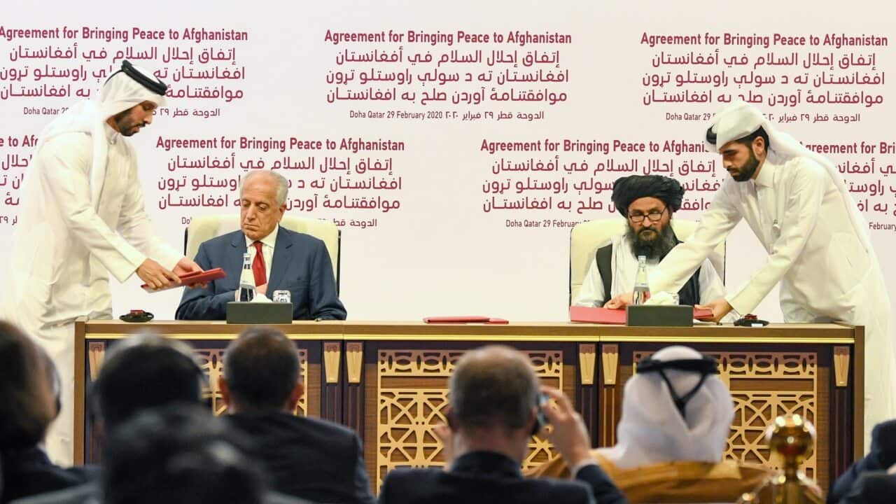 US Special Representative for Afghanistan Reconciliation Zalmay Khalilzad (2-L) and Taliban co-founder Mullah Abdul Ghani Baradar sign the US-Taliban deal.