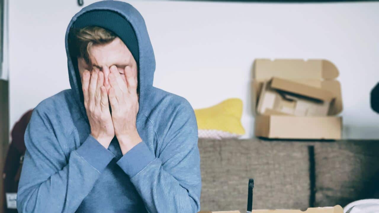 man holding head sad