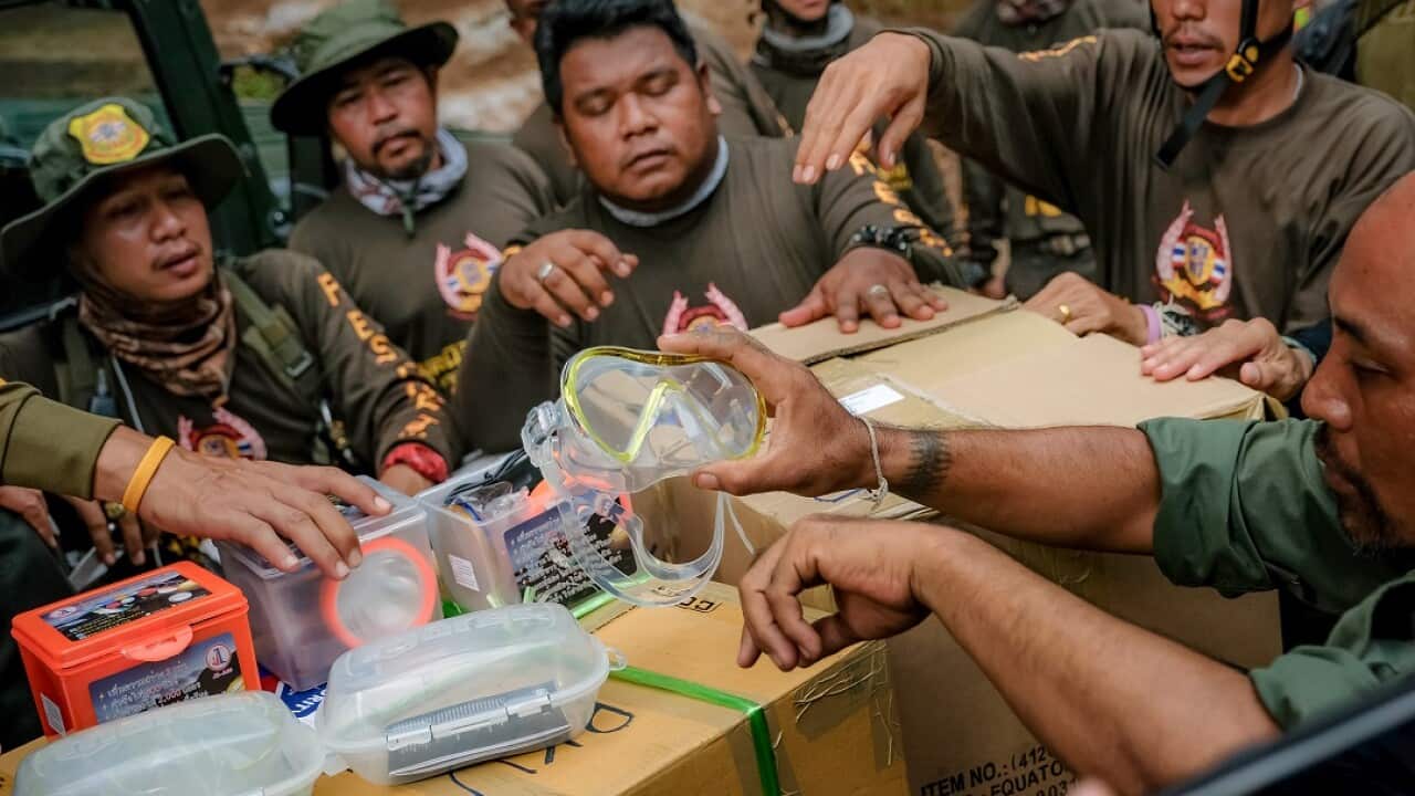 Rescuer workers prepare small diving mask to deliver inside Tham Luang Nang Non cave.