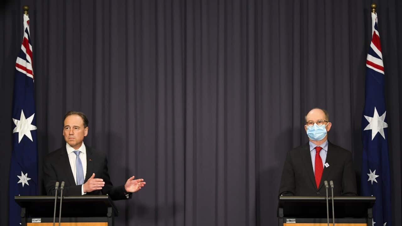 Australian Health Minister Greg Hunt (left) and Australia’s Chief Medical Officer Paul Kelly speak to the media during a press conference at Parliament House in Canberra, Wednesday, October 20, 2021. (AAP Image/Lukas Coch) NO ARCHIVING
