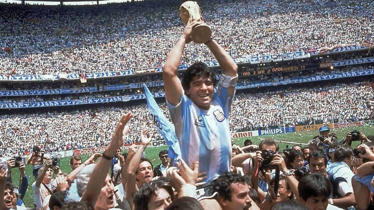 Diego Maradona holding the World Cup in Mexico in 1986