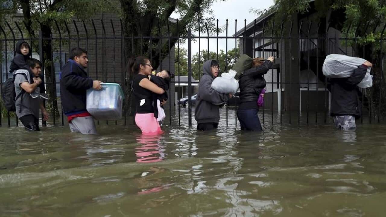 Residents from Bayou Parc at Oak Forest carry their belongings