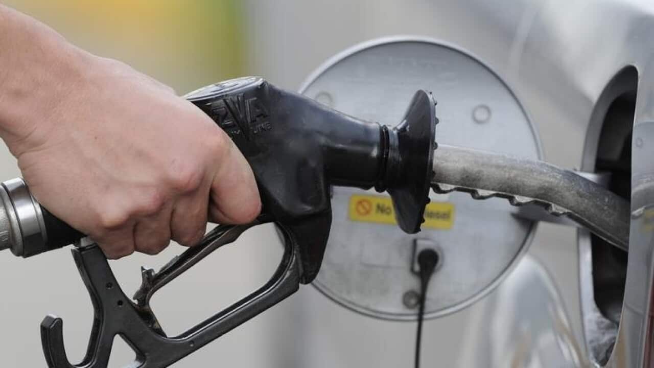 File image of man pumping petrol at a service station