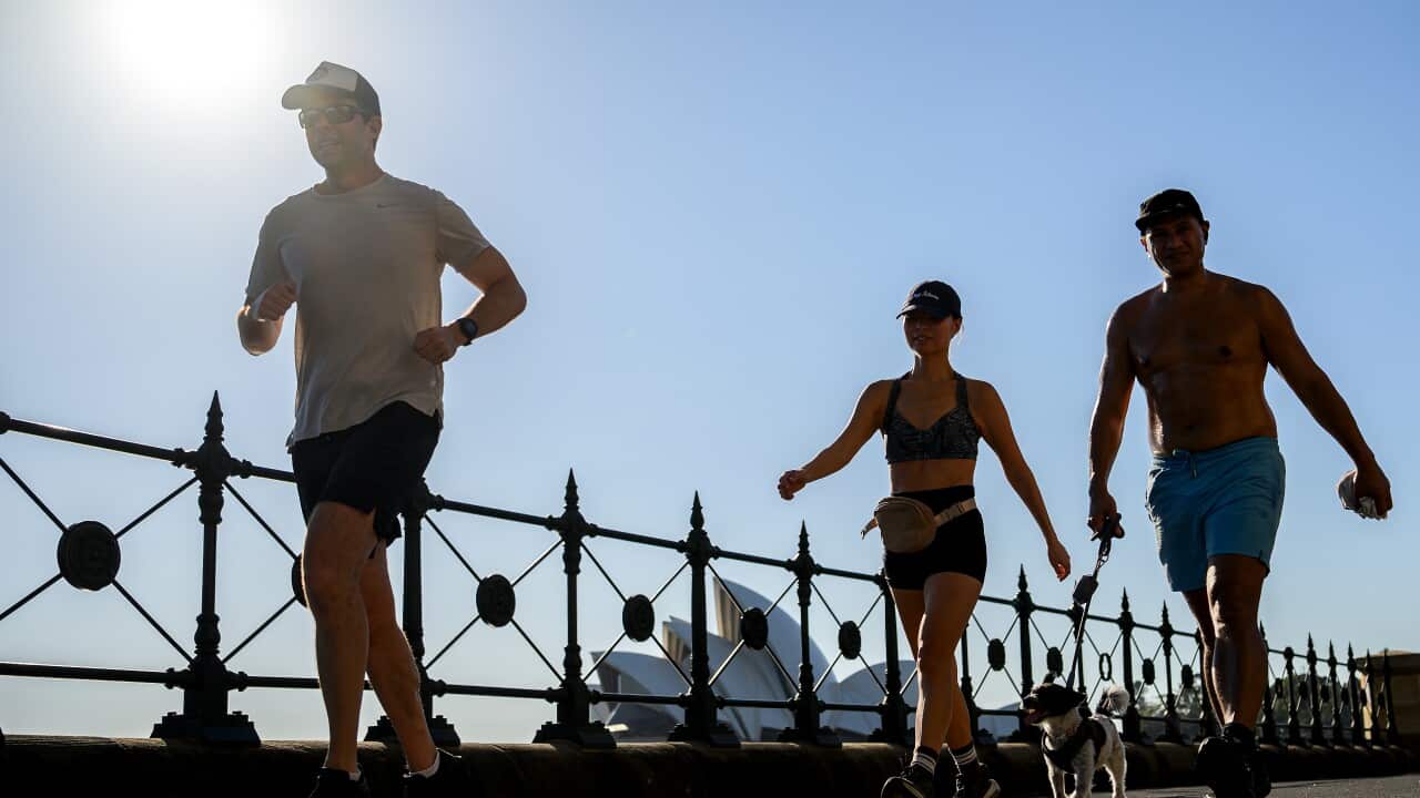A group of people walking in hot weather