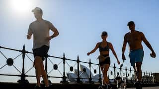 A group of people walking in hot weather