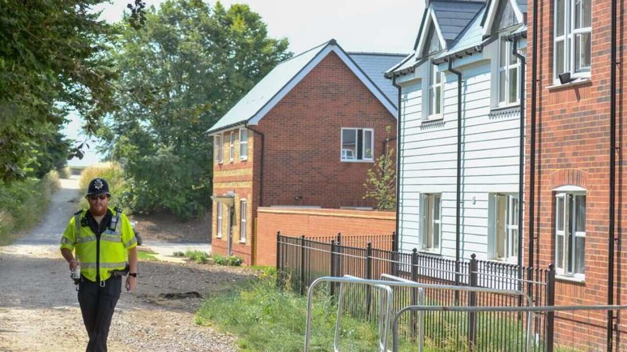 Police at the home where the couple were found unconscious