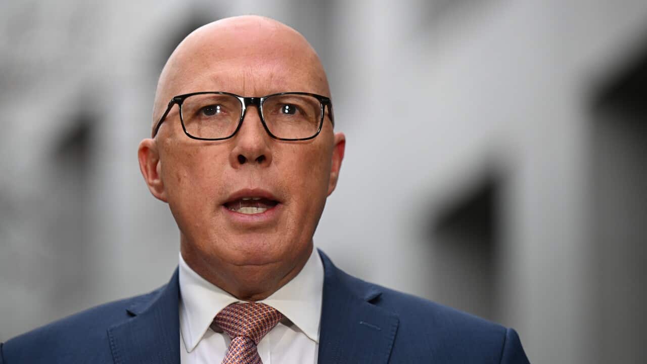 A man wearing glasses and a tie