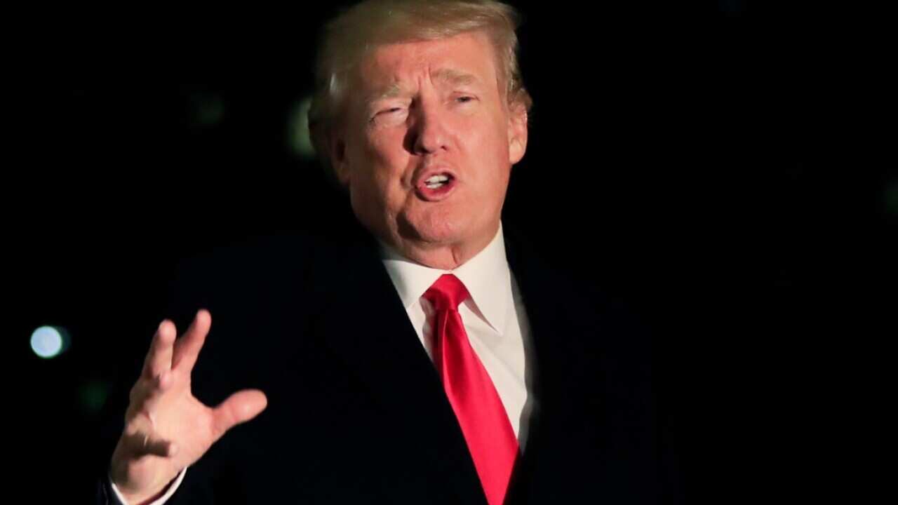 President Donald Trump speaks to reporters upon arrival at the White House in Washington, Friday, Jan. 26, 2018, from the World Economic Forum 