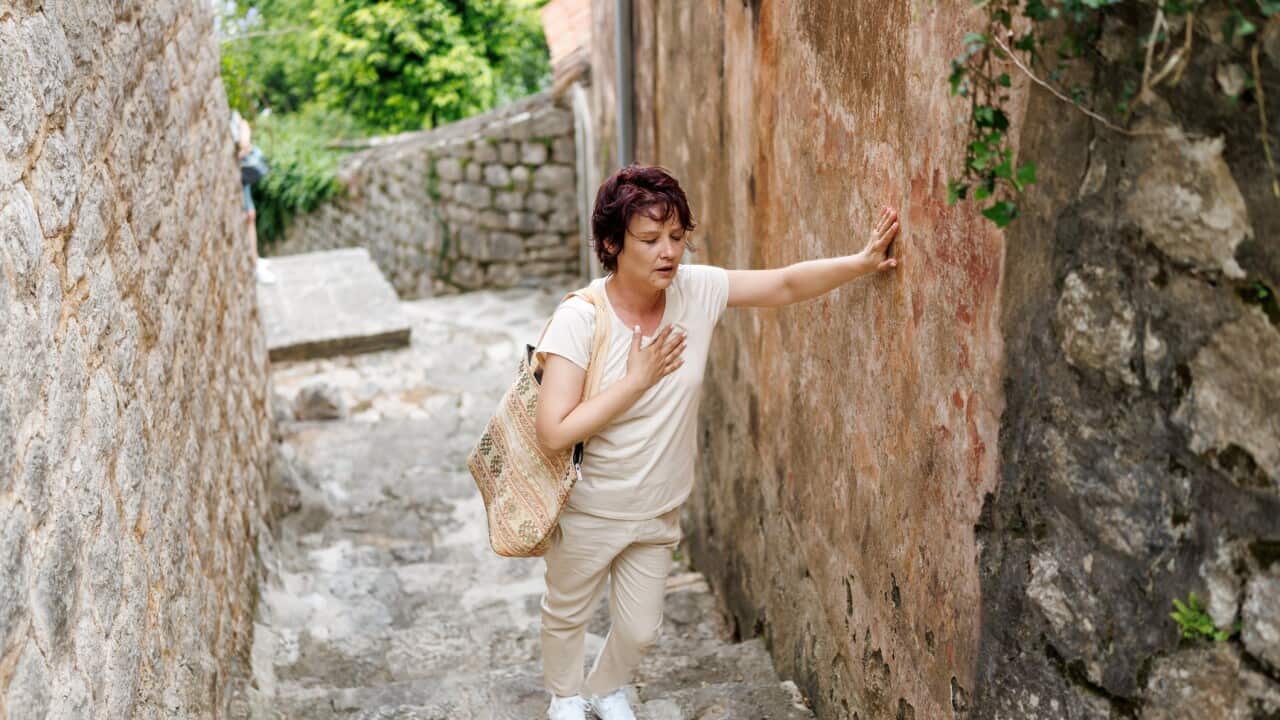 Woman having heart problems on vacation