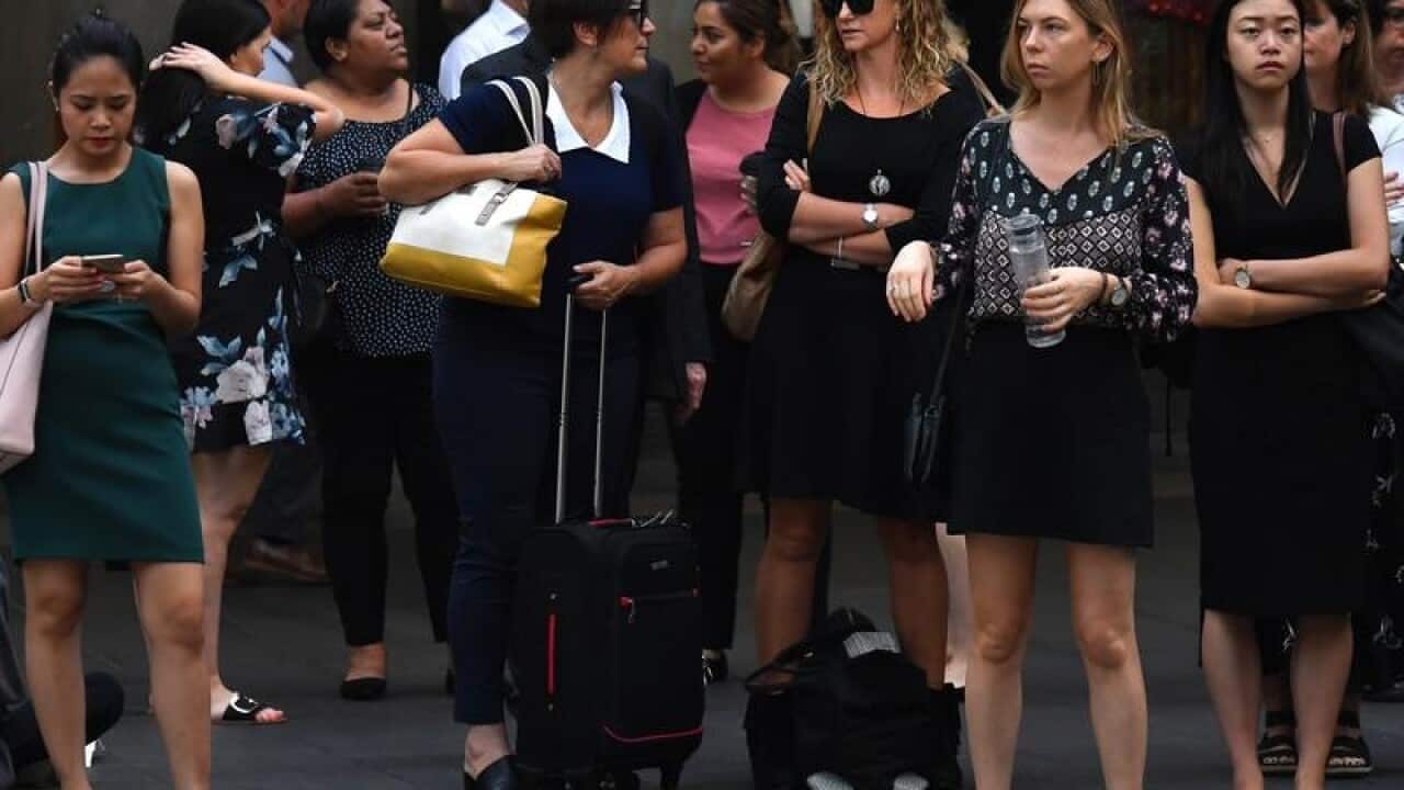 Office workers are seen arriving to work.