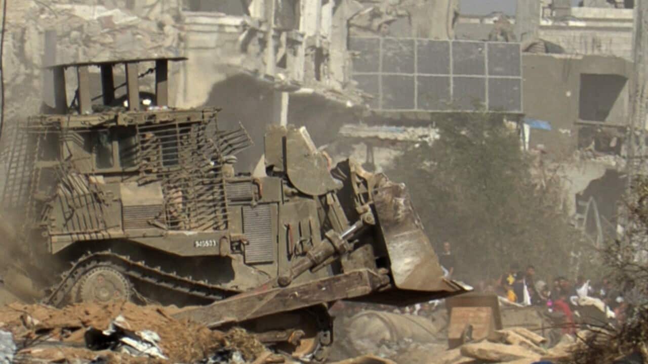 An Israeli military bolldozer rolling through Gaza City