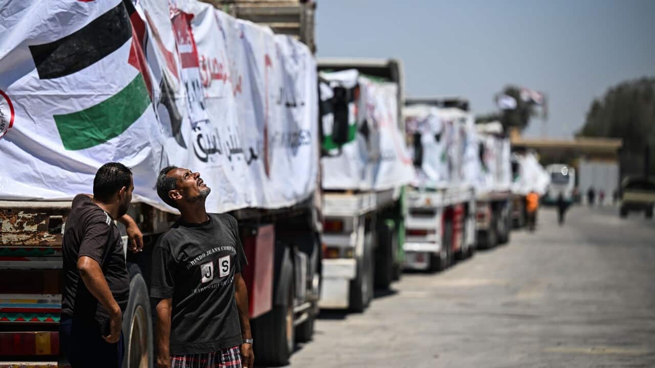 Trucks with humanitarian aid wait at Rafah border