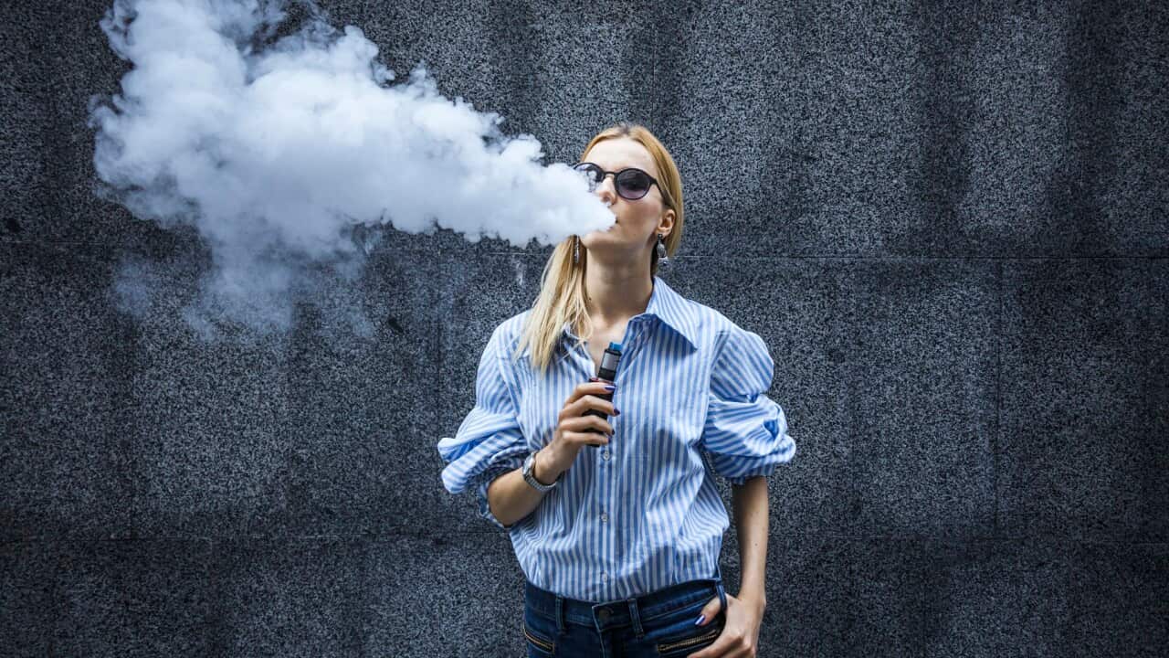 Young female smoking electronic cigarette