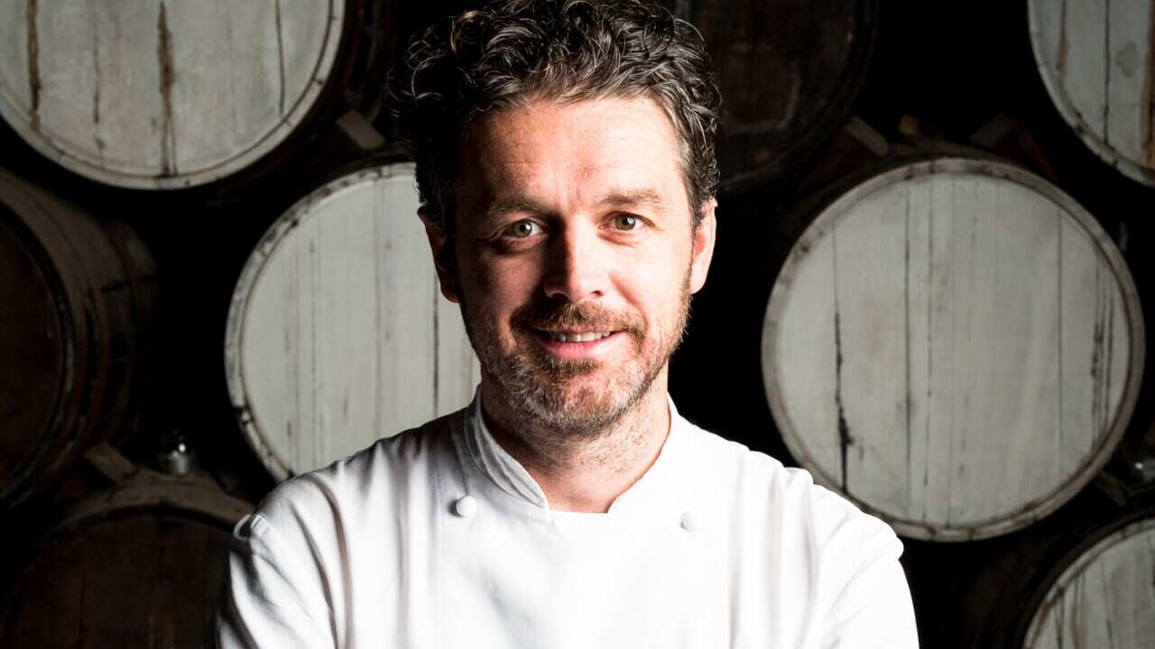 A man smiling and looking into the camera.