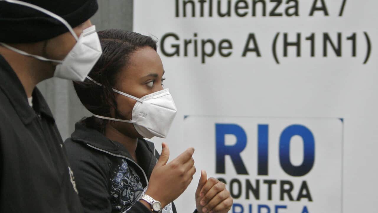 File photo from 2009: A woman and a man wearing masks to prevent infection from swine flu arrive at  the Miguel Couto hospital in Rio de Janeiro.