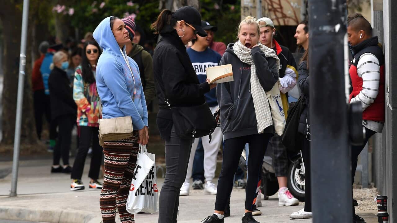 People are seen waiting in line at the Prahran Centrelink office in Melbourne