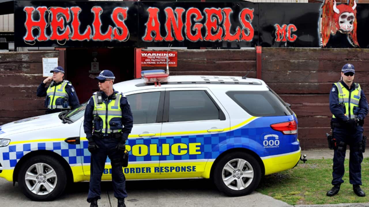 Police stand guard outside a Hells Angels club house in Melbourne
