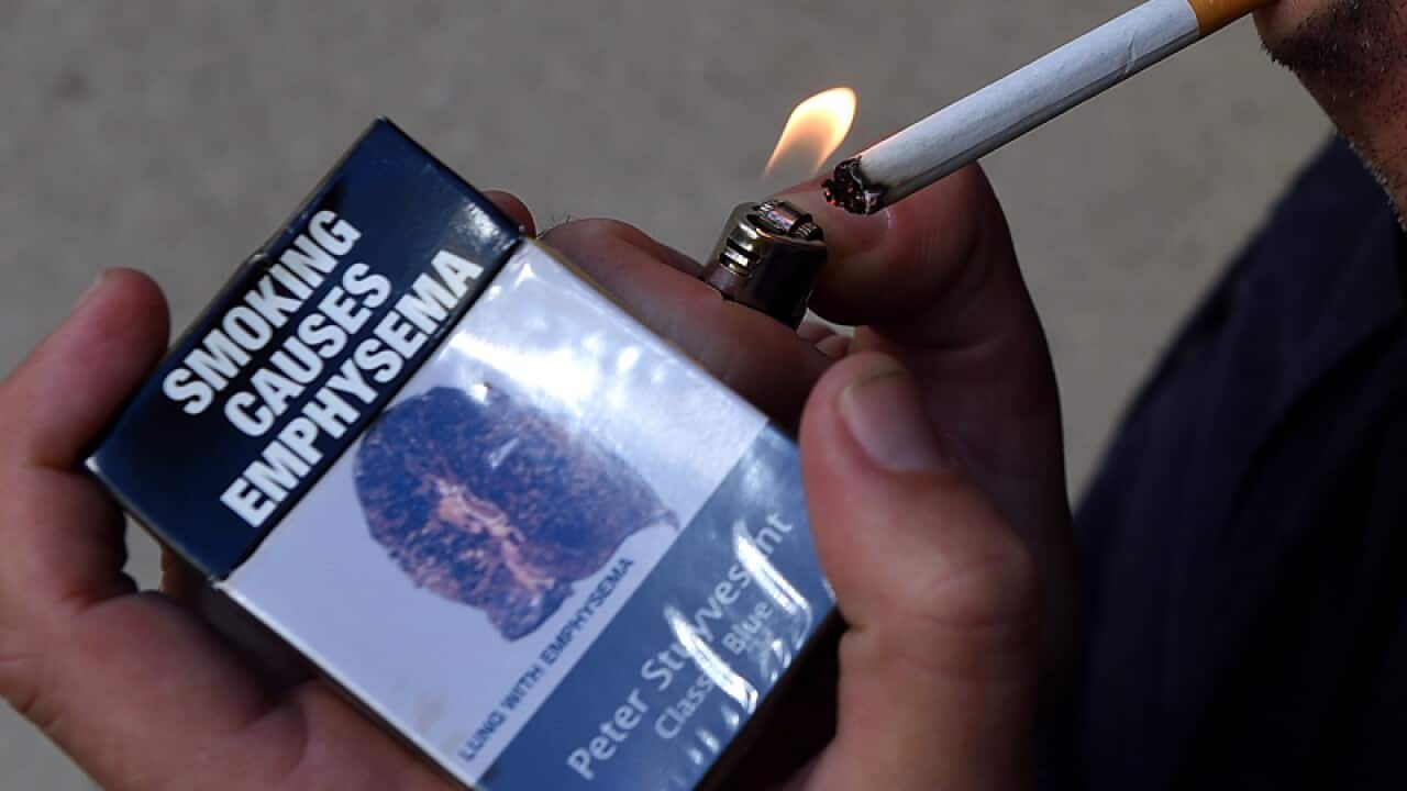 A man lights a cigarette