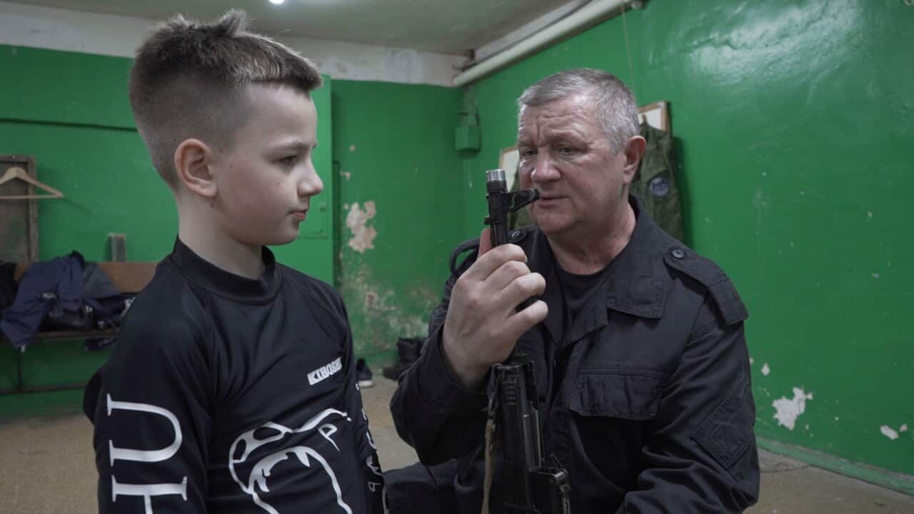 Kaskad leader Gennady Korotaev teaches 10-year-old Vitaly how to assemble and dissemble a gun.